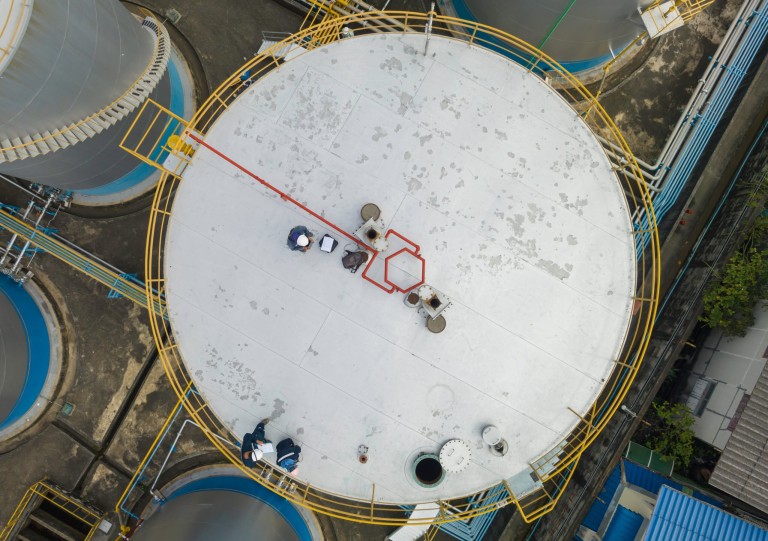 Male top view chemical industry tank storage white carbon steel worker are for inspection ultrasonic thickness roof plate dome top of storage tank. Male,Top,View,Chemical,Industry,Tank,Storage,White,Carbon,Steel